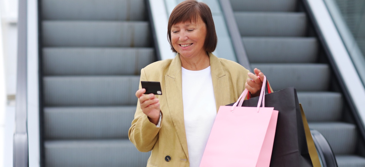middle-aged-woman-carrying-shopping-bags-and-smiling
