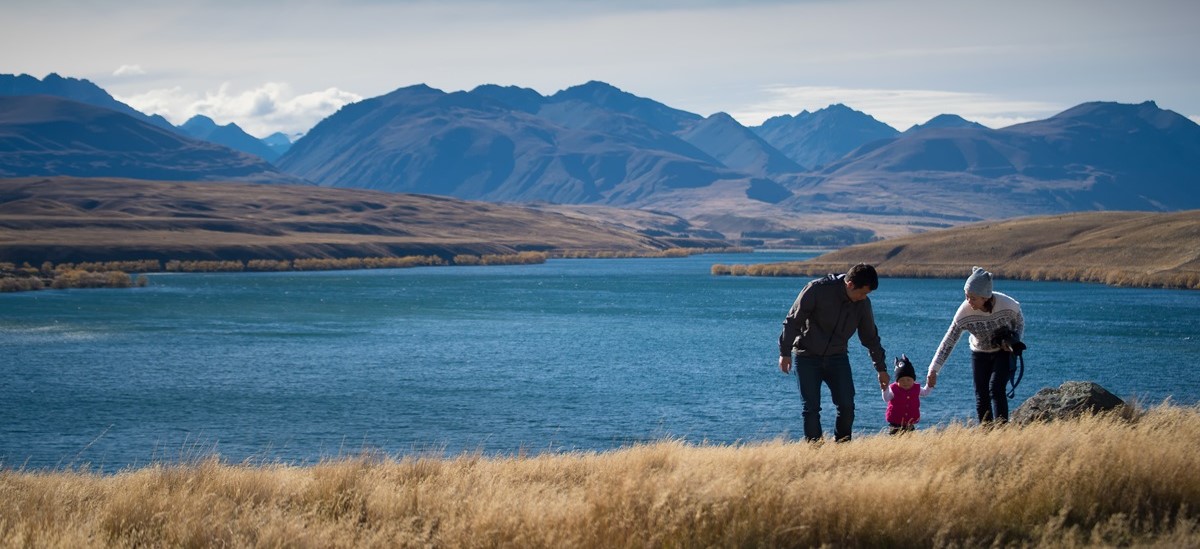 New Zeland landscape with family walking towards camera