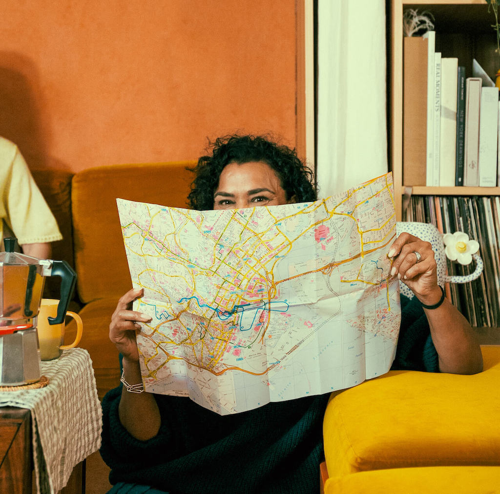 a Wise travel money card and a mobile putting on a map